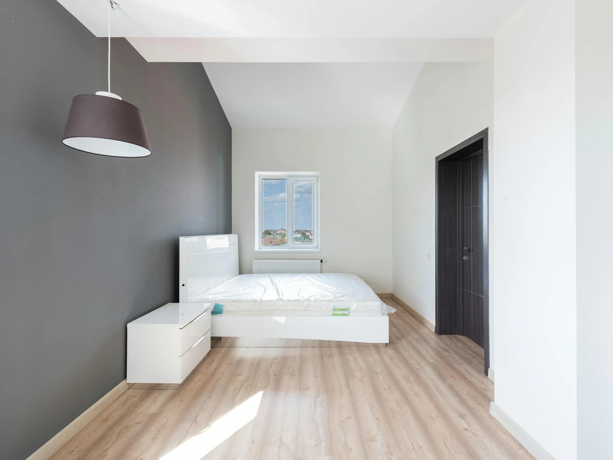 Minimalist master bedroom with dark paint finish by Beaconsfield Decorators in Beaconsfield