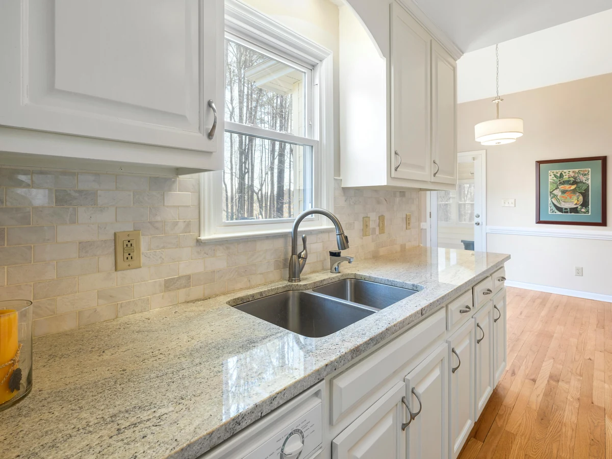 White kitchen with granite worktop, painted cabinets by Beaconsfield Decorators