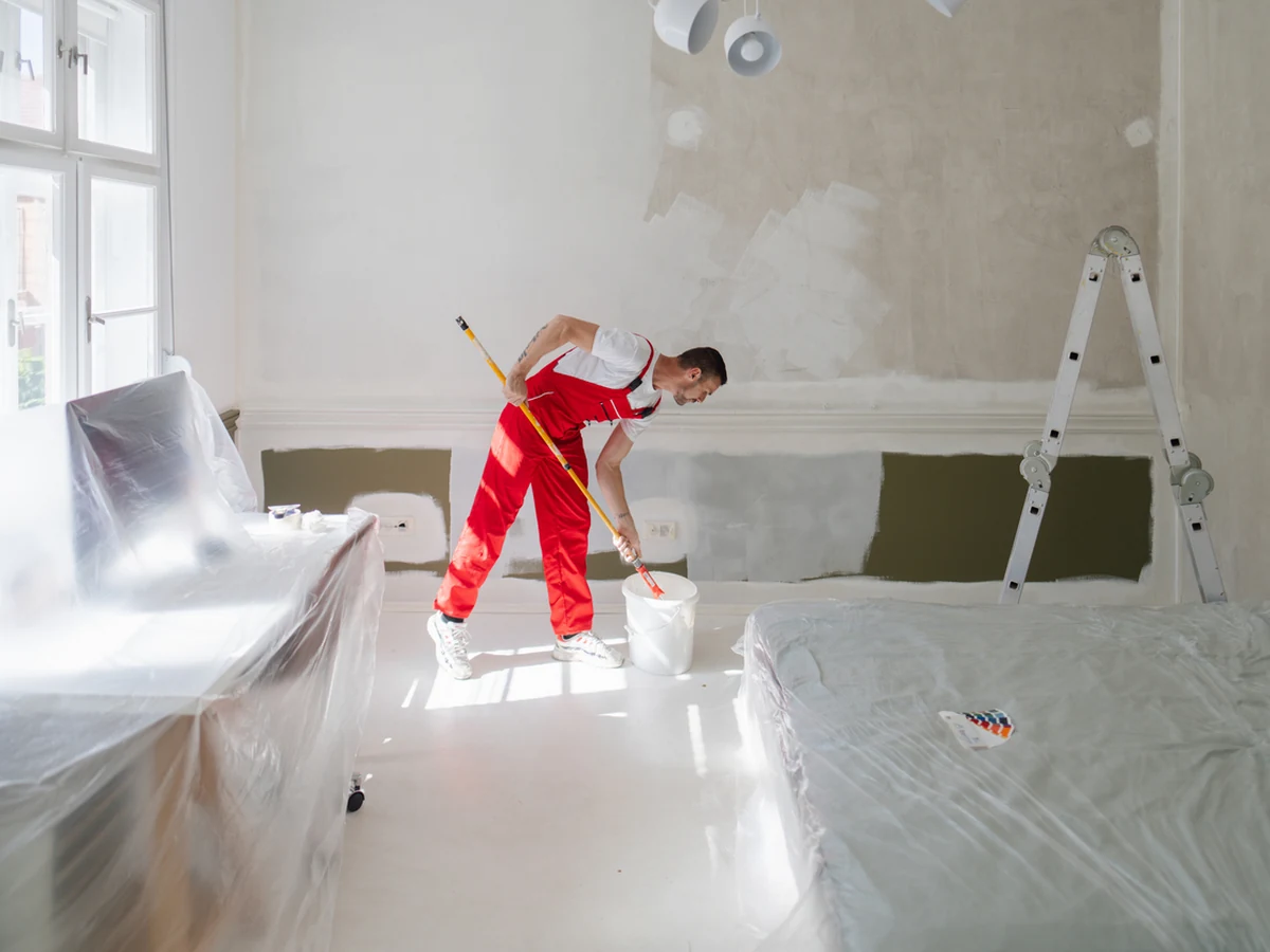 Professional painter in red overalls with brush, Beaconsfield Decorators